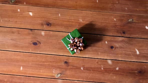 Gift Box in Green Wrapper with Bow Wooden Boards