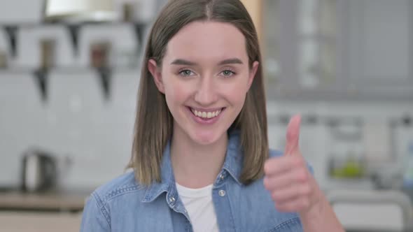 Portrait of Beautiful Young Woman Showing Thumbs Up