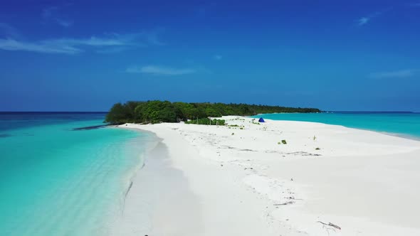 Aerial top view nature of tranquil seashore beach vacation by clear lagoon and white sandy backgroun