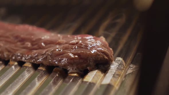 Grilled Meat in Barbecue with Flames and Coals