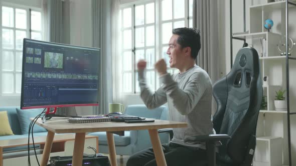 Asian Video Editor Man Being Happy Finishing Editing Video By Desktop Computer While Work At Home