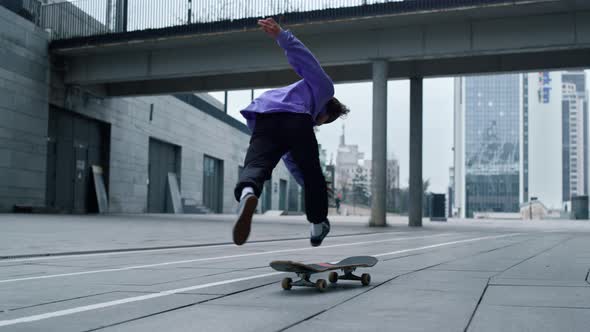 Sporty Skater Making Trick on Board Outdoor