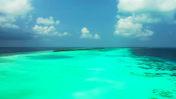 Daytime flying tourism shot of a summer white paradise sand beach and blue sea background in high re