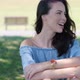 Portrait of Attractive Brunette Woman in Blue Dress Sitting in a Park - VideoHive Item for Sale