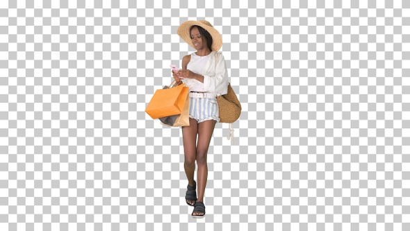 Happy african american woman in hat walking, Alpha Channel