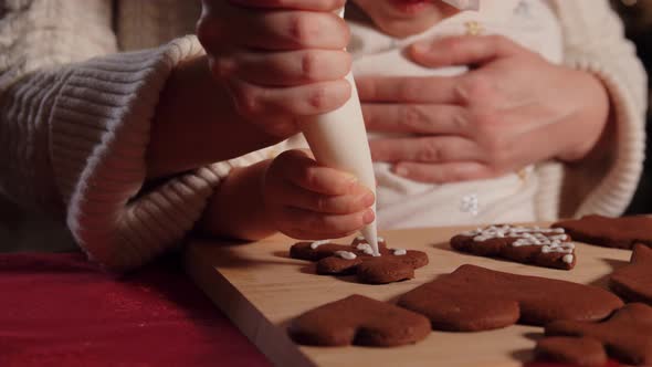 Mother and Daughter Decorating Gingerbread at Home