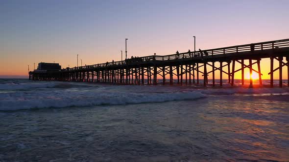 Waves rolling on the beach during sunset at Newport Beach