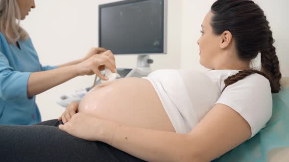 Pregnant Woman Lying at Clinic During Sonogram Procedure