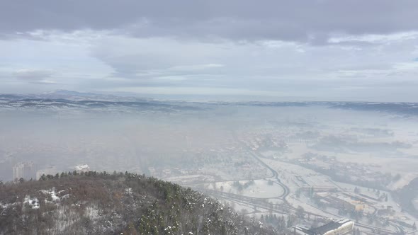 High air pollution over the city in the valley 4K drone video