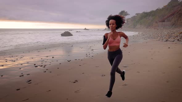 Slow motion shot of an Somali woman jogging on the beach