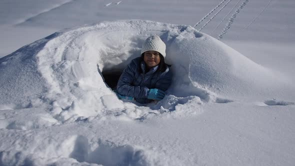 Cute Asian Girl Playing On Snow Outdoors 