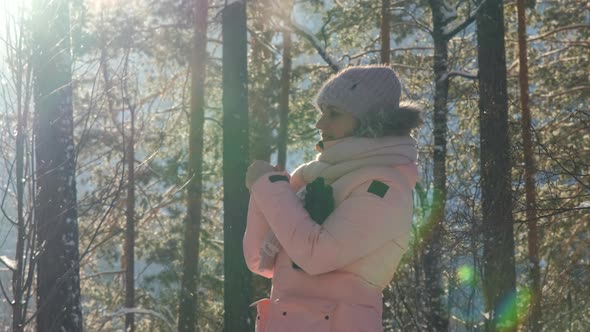 Young Woman Warming Her Hands in Freezing Day