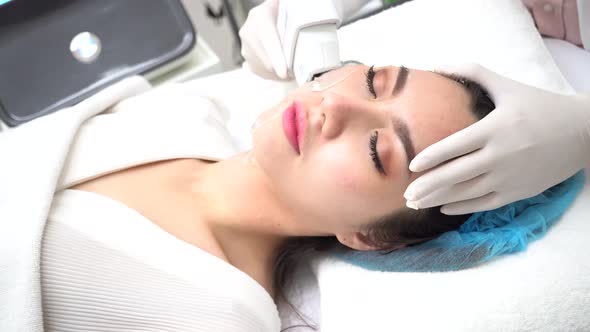 Young Asian Woman Getting IPL and Laser Treatment By Beautician at Clinic