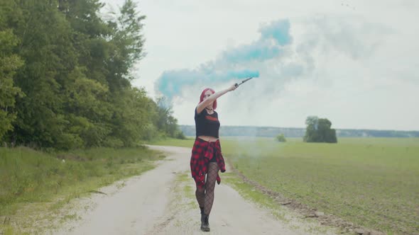 Happy Woman Dancing Holding Smoke Bomb Outdoors