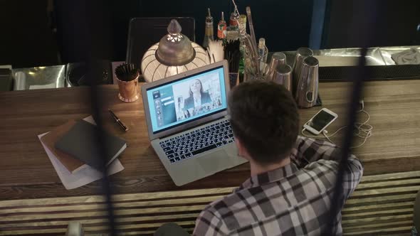 Businessman Talking on Video Call at Bar