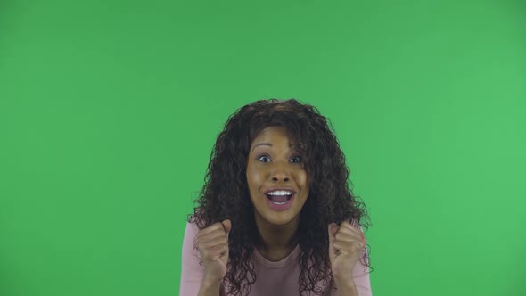 Portrait of Beautiful African American Young Woman Is Looking at the Camera with Excitement, Then