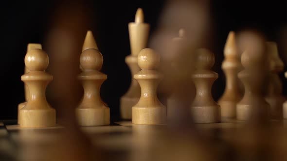 Close Up of White and Black Chess Pieces on Board