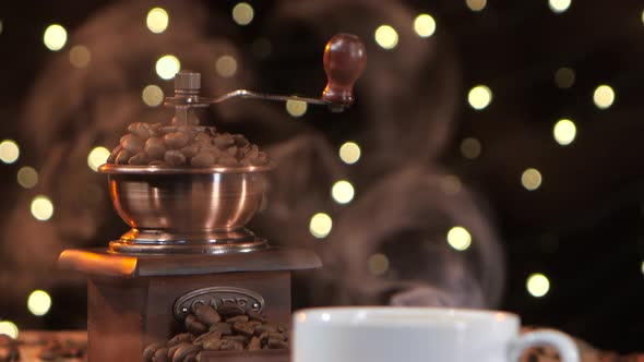 Coffee Mill with Beans. Closeup Smoke with a White Cup