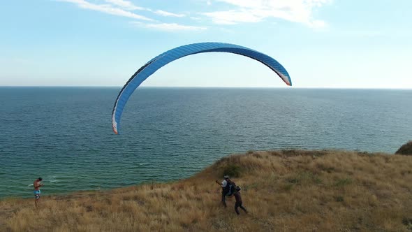 Paraglider Is Landing on the Beach, Aerial View on the Sea