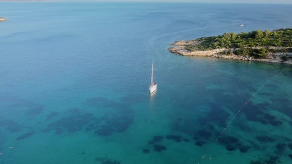 View From Above Aerial View of a Boat Sailing on a Transparent and Turquoise Sea