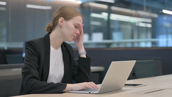 Businesswoman with Headache Working on Laptop
