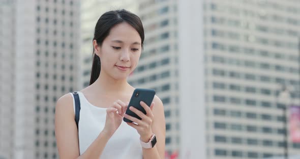 Woman use of mobile phone in city