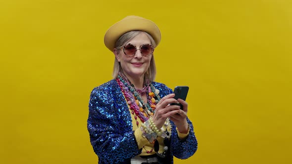 Stylish Elderly Woman On Yellow Background