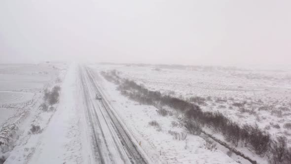 Car Driving Through a Snow Storm in the Arctic