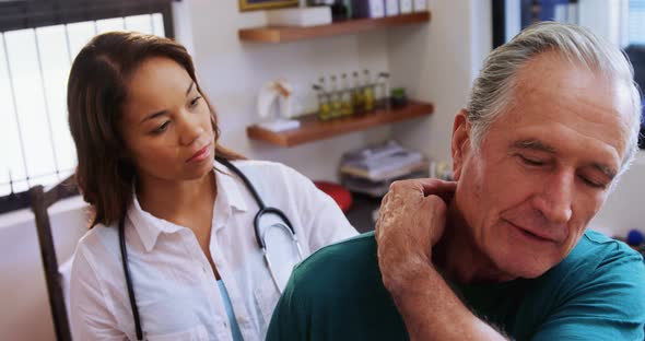 Senior man receiving neck massage from physiotherapist 4k