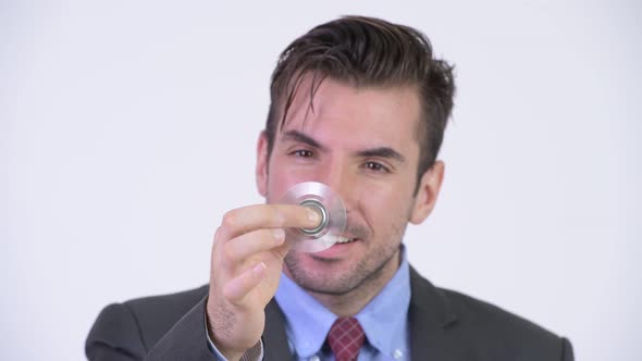 Young Happy Hispanic Businessman Playing with Fidget Spinner