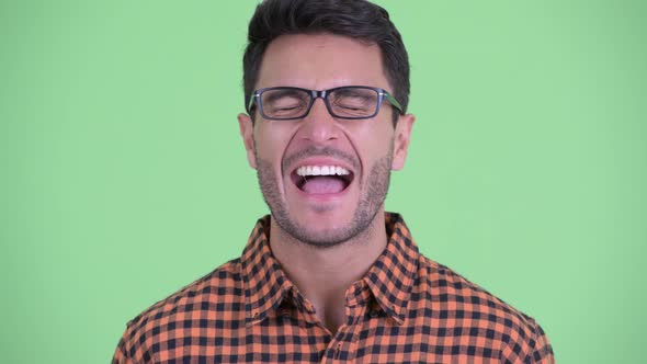 Face of Happy Young Hispanic Hipster Man Smiling and Laughing