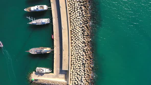 063_ojra.uas_Port_FrontalTraveling_AerialView_SunnyDay_4k. Aerial view of the port jetty with boats