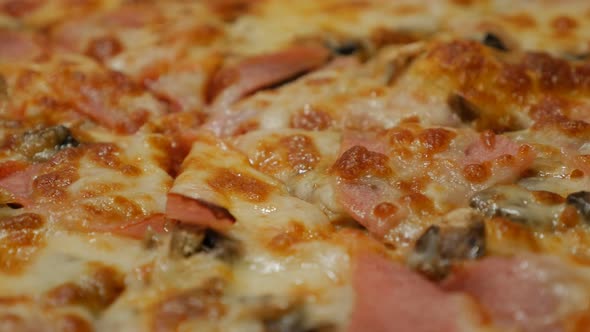 Pan over tasty baked pizza surface close-up 4K 2160p 30fps UltraHD footage - World famous Italian pi