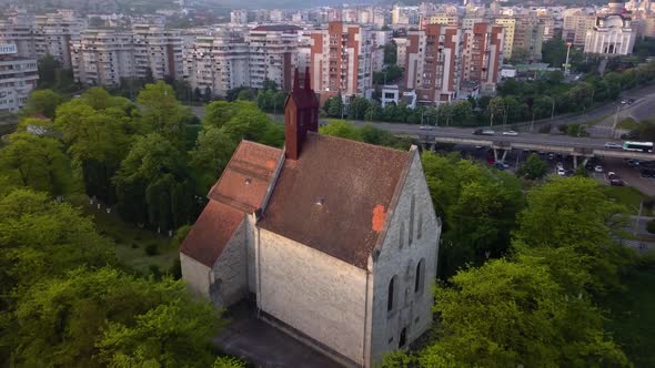 Round View Of Beautiful Church between trees forest And View of monument Town Cluj, Romania, Transyl