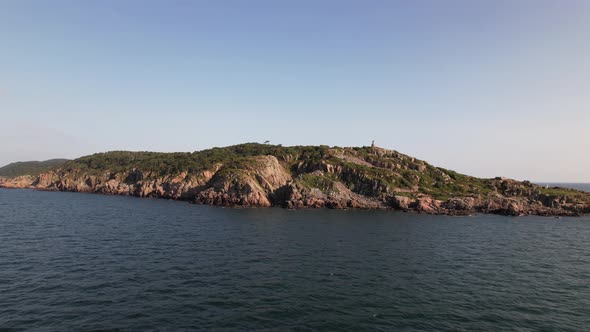 Aerial view, panning left, cliff coast and pier. Kullaberg Sweden