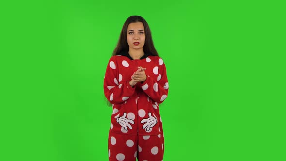 Beautiful Girl in Red Fleece Pajamas Is Clapping Her Hands Indifferent. Green Screen