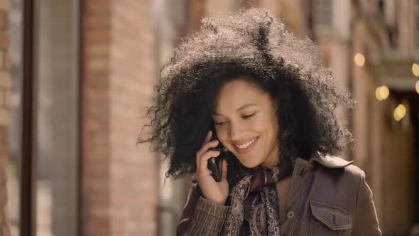 Portrait of Young African American Woman Talking on Smartphone