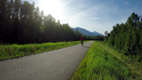 Woman riding unicycle on road