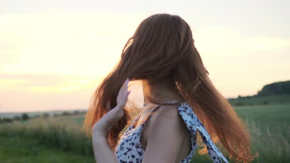 Adorable Playful Red Hair Happy Girl with Freckles Dressed Dancing at Sunset