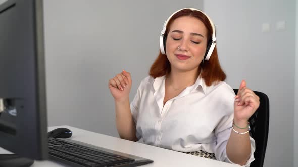 Woman Listening to Music While Working on Computer in the Office 4K