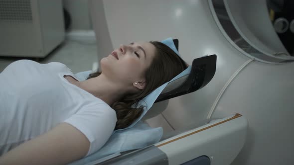 Female Patient On The Ct Or Mri Scanner Machine During X-Ray Process