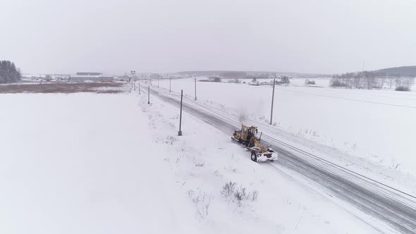 Aerial view of Snowblower Grader Clears Snow Covered Country Road 02