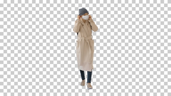 Woman dressed in a coat wearing putting, Alpha Channel