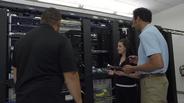 View of three people discussing hardware