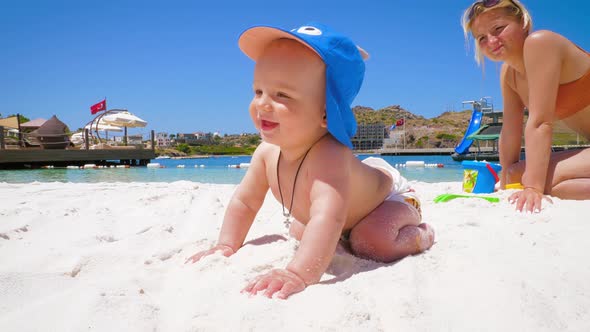 Emotions of a Little Happy Boy Who Is on the Beach for the First Time with Mom