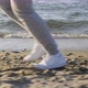 Following Shot of the Legs of a Runner Exercising on the Beach - VideoHive Item for Sale