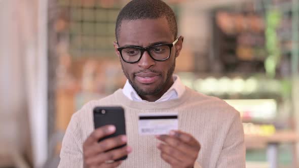 Portrait of African Man Making Online Payment on Smartphone