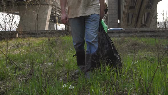  Legs of Man Walking with Trash Bags