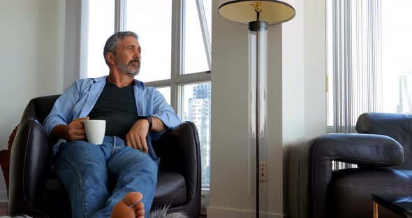 Man checking time on smartwatch while having coffee 4k