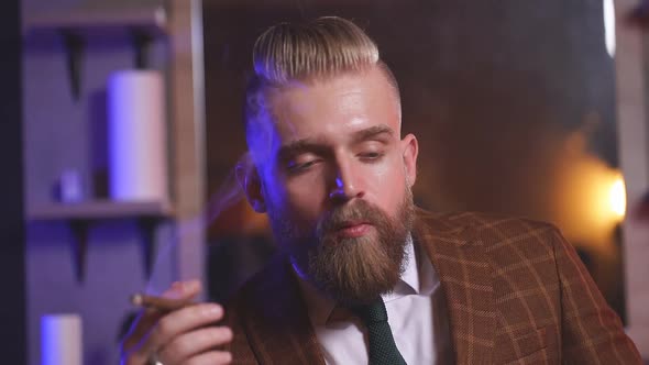 Confident Caucasian Male with Beard in Formal Stylish Suit Sit Smoking Cigar, Relax